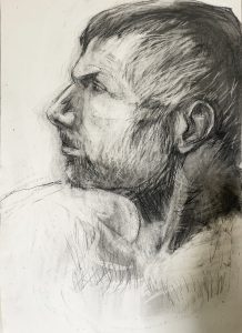 Sideview of male model short hair, close-cropped beard, black medium on white paper.