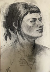 Sideview of female model, black hair pulled back into a clip. Black medium on white paper.